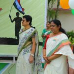 Group of indian adults at an outdoor flag wearing event several women in sarees with india flags on their blouses Sarathi school habsiguda hyderabad